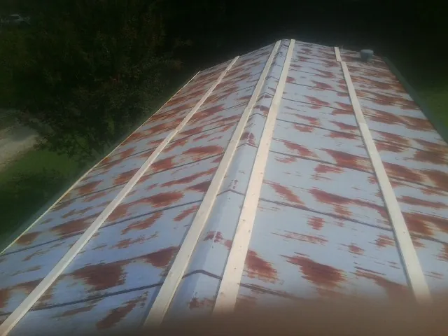 Rusted metal roof panels with new wood purlins before replacement — Storm Damage Roof Repair in Sandisfield by Roofing Brothers