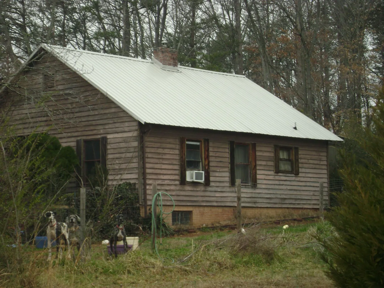 White metal roof on an old wood sided farmhouse, from a Metal Roof Installation job in Sandisfield